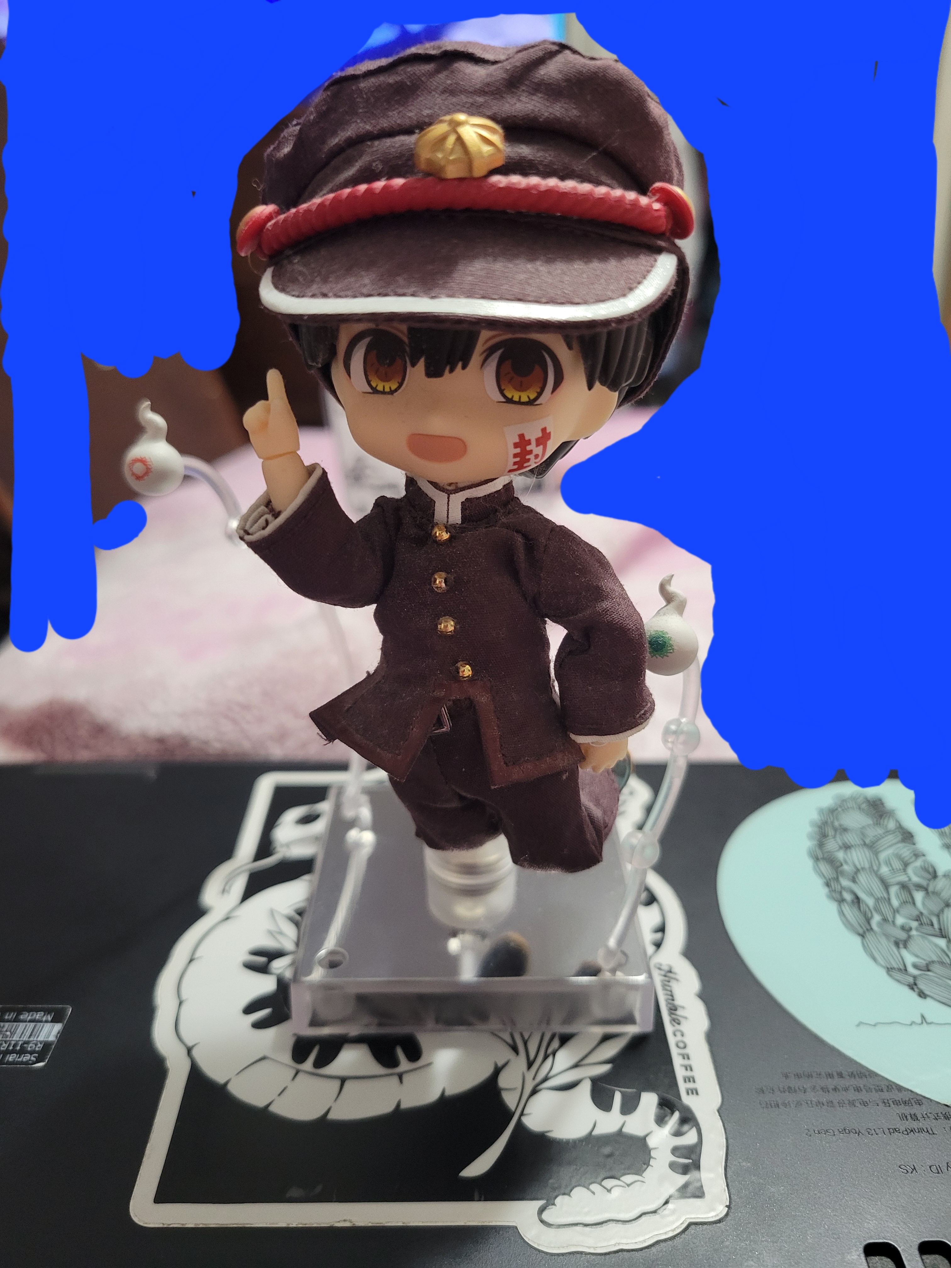 Hanako-kun nendroid doll that has removable clothing. The figure is floating with one hand pointing up and his legs bent as his hakujoudai surround him.